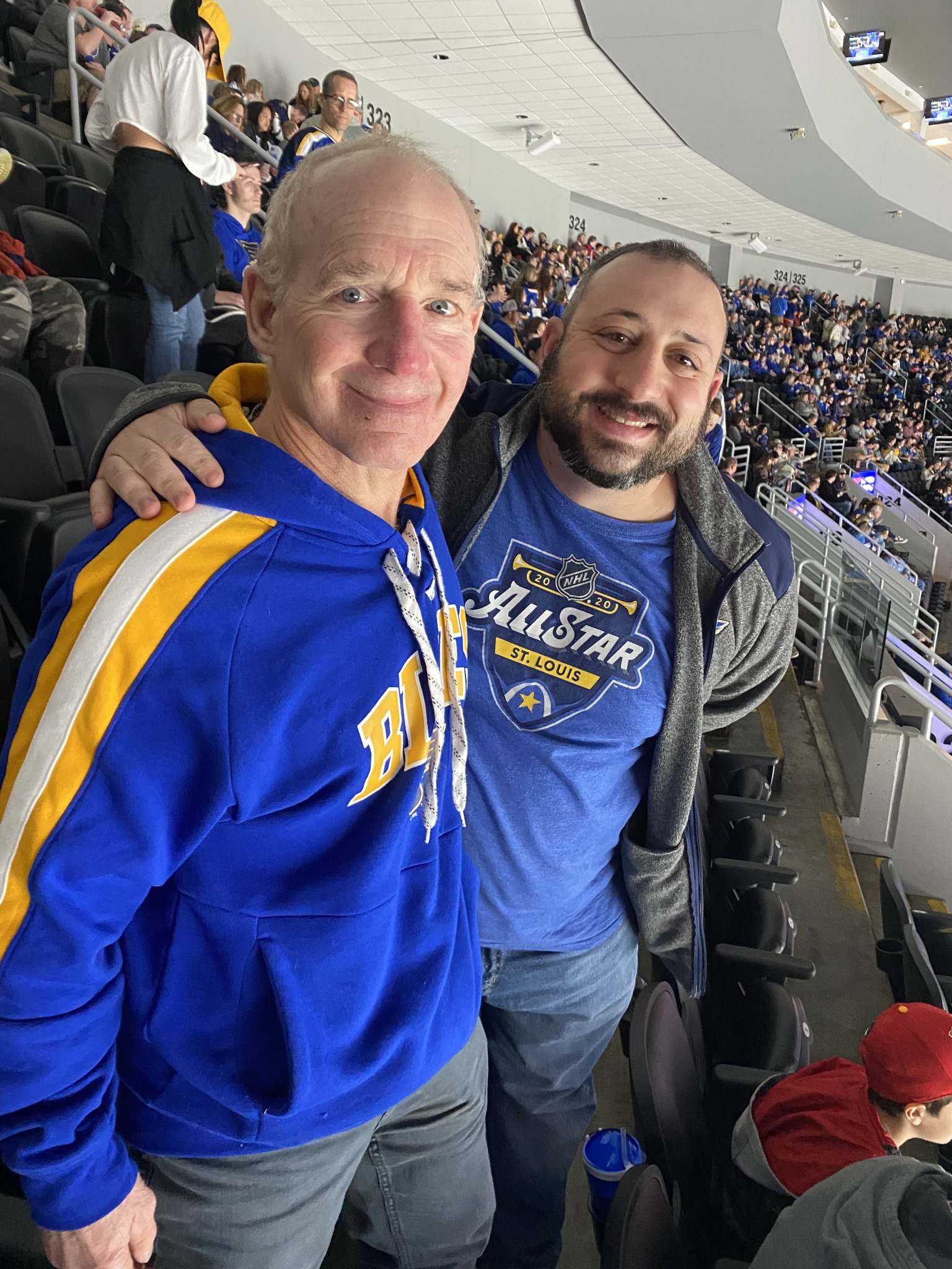 Father and son together in the stands at a hockey game